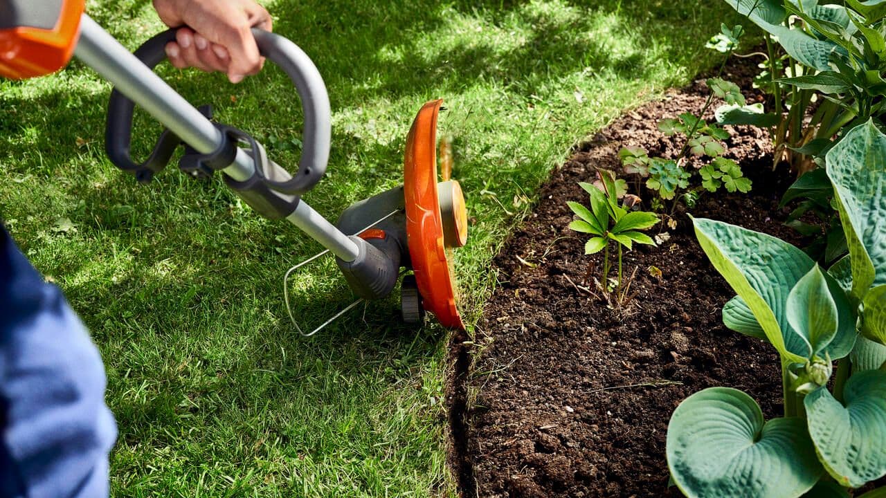 man wearing ppe with chainsaw